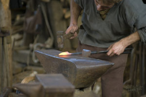 Blacksmith uses medieval style of anvil in his craft